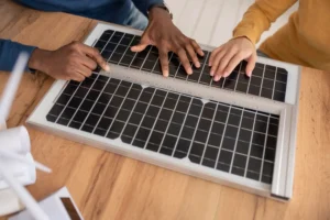 hands-measuring-solar-panel-with-ruler-on-wooden-table