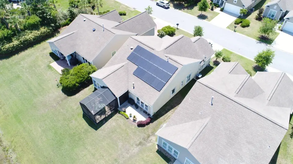 drone-view-of-a-house-with-solar-panels-on-a-tilted-well-oriented-roof